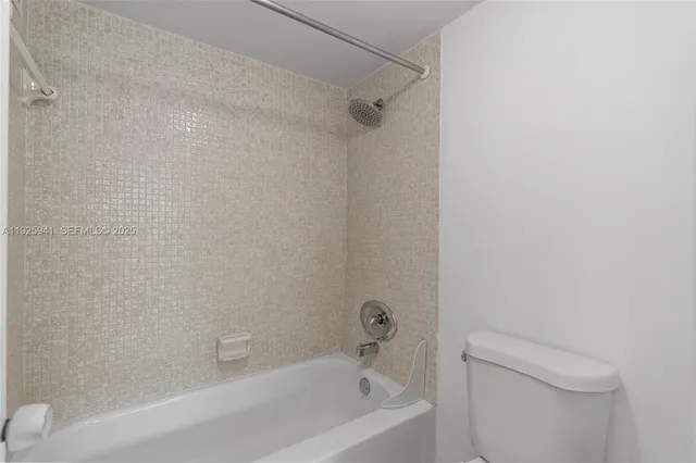 a bathroom with a bathtub and a toilet