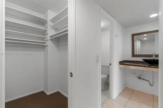 a room with a bench and cabinets