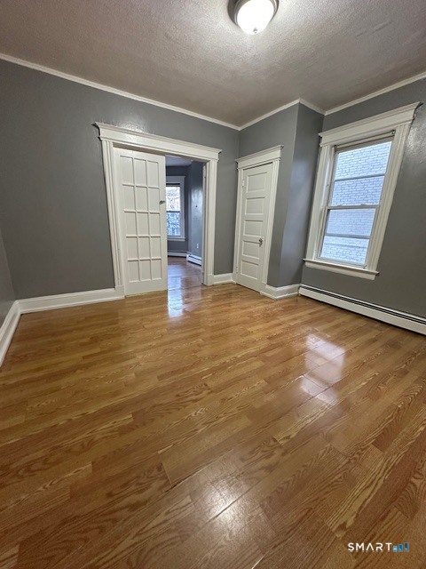 27 Bond Street Hartford, CT 06114 - Photo 6 of 10 a view of an empty room with window and wooden floor