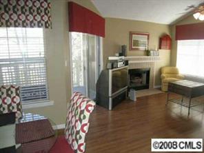 5003 Sharon Road, Unit H Charlotte, NC 28210 - Photo 2 of 8 a kitchen with furniture and a fireplace
