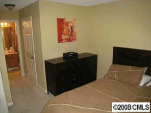 5003 Sharon Road, Unit H Charlotte, NC 28210 - Photo 3 of 8 a bedroom with a bed and a flat screen tv