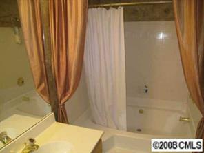 5003 Sharon Road, Unit H Charlotte, NC 28210 - Photo 4 of 8 a bathroom with a shower and a tub