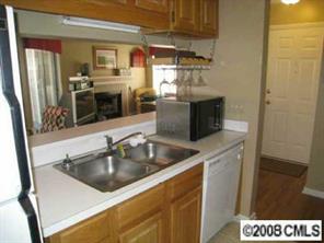 5003 Sharon Road, Unit H Charlotte, NC 28210 - Photo 7 of 8 a kitchen with a sink and refrigerator