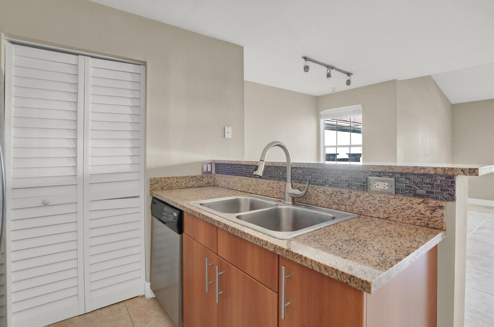 1215 Crystal Way, Unit N Delray Beach, FL 33444 - Photo 12 of 29 a kitchen with a granite countertop sink and natural light