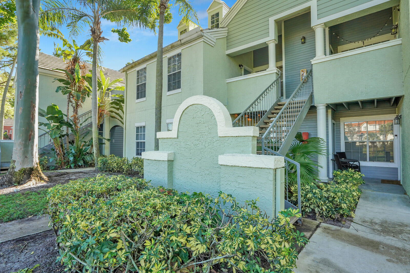 1215 Crystal Way, Unit N Delray Beach, FL 33444 - Photo 21 of 29 a front view of a house with a garden
