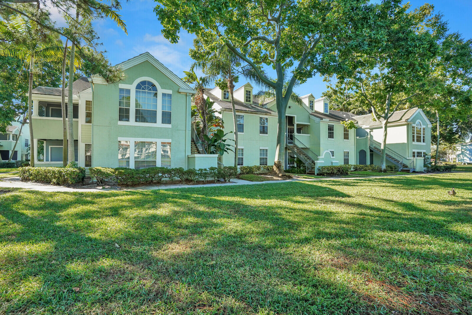1215 Crystal Way, Unit N Delray Beach, FL 33444 - Photo 23 of 29 a front view of a house with a yard