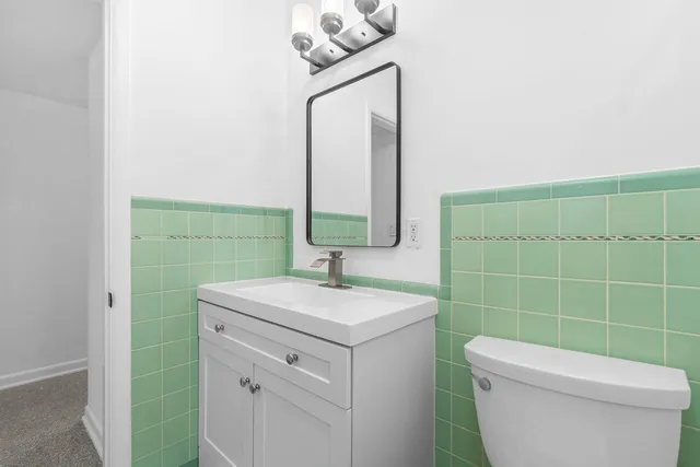 a view of a grassy field with trees in the background