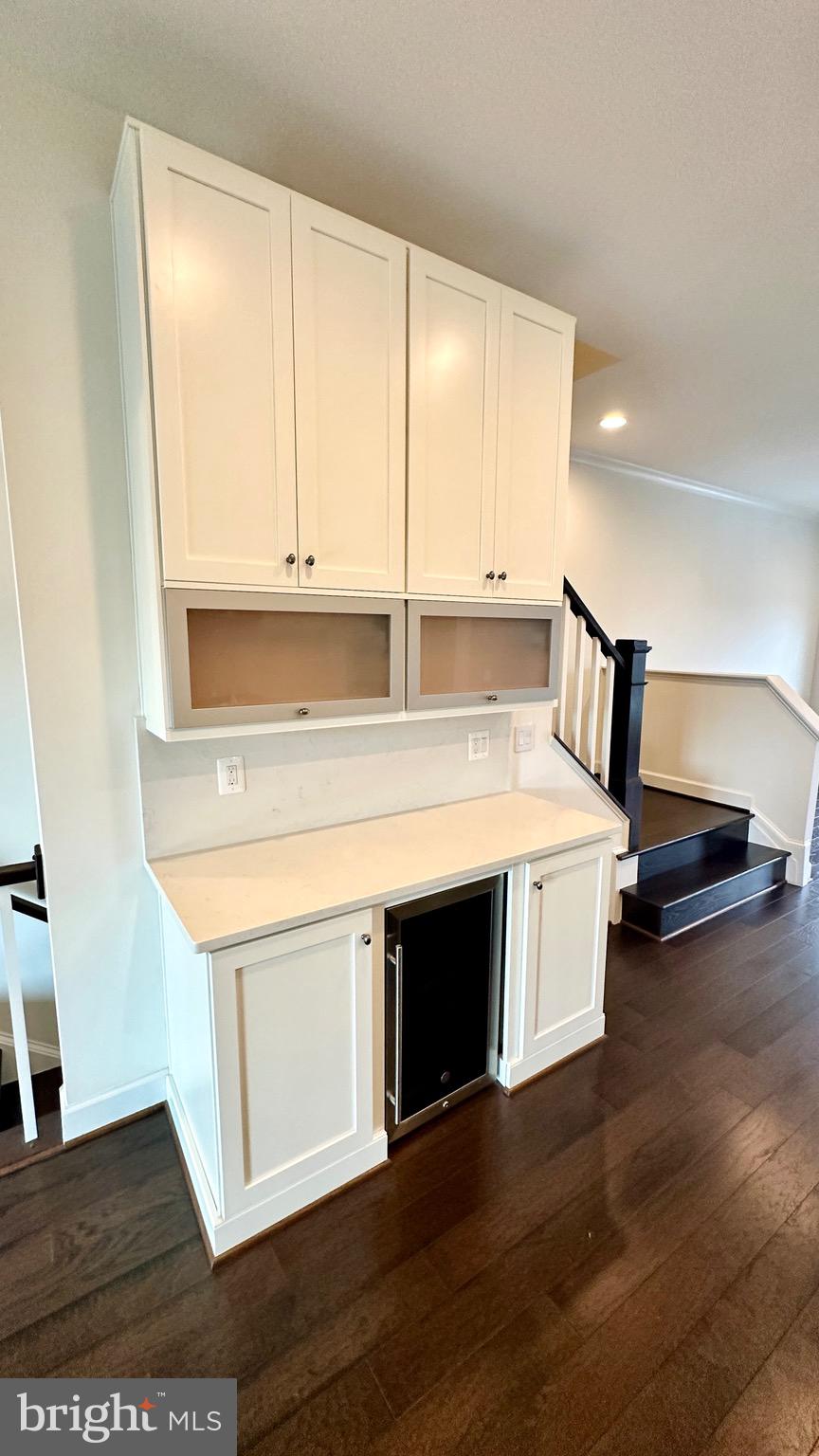 20265 Oak Bluff Drive Ashburn, VA 20147 - Photo 16 of 42 a kitchen with stainless steel appliances granite countertop a stove a sink and a microwave oven with white cabinets