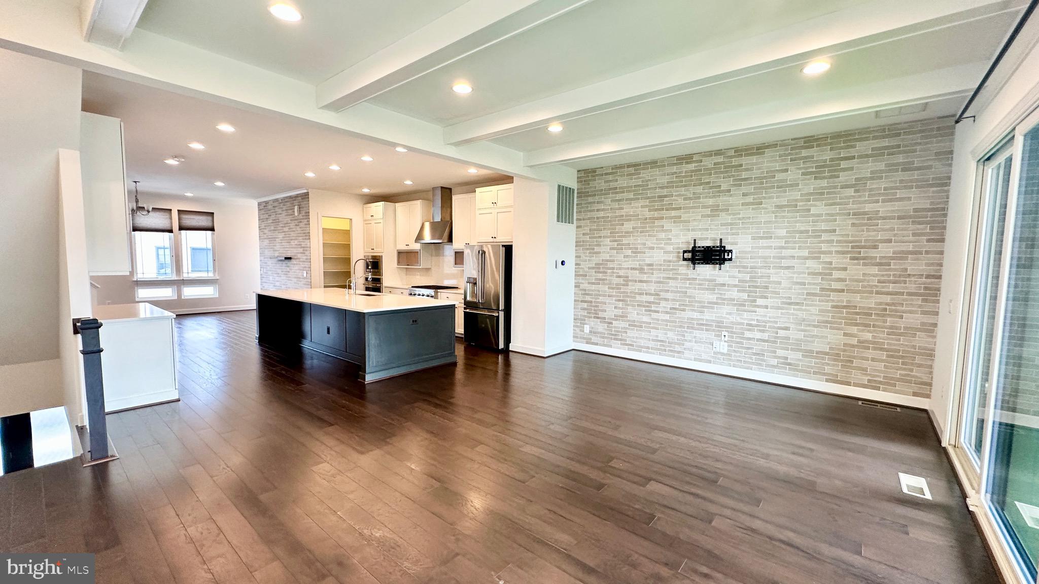 20265 Oak Bluff Drive Ashburn, VA 20147 - Photo 17 of 42 a living room with stainless steel appliances kitchen island granite countertop wooden floor and a large window