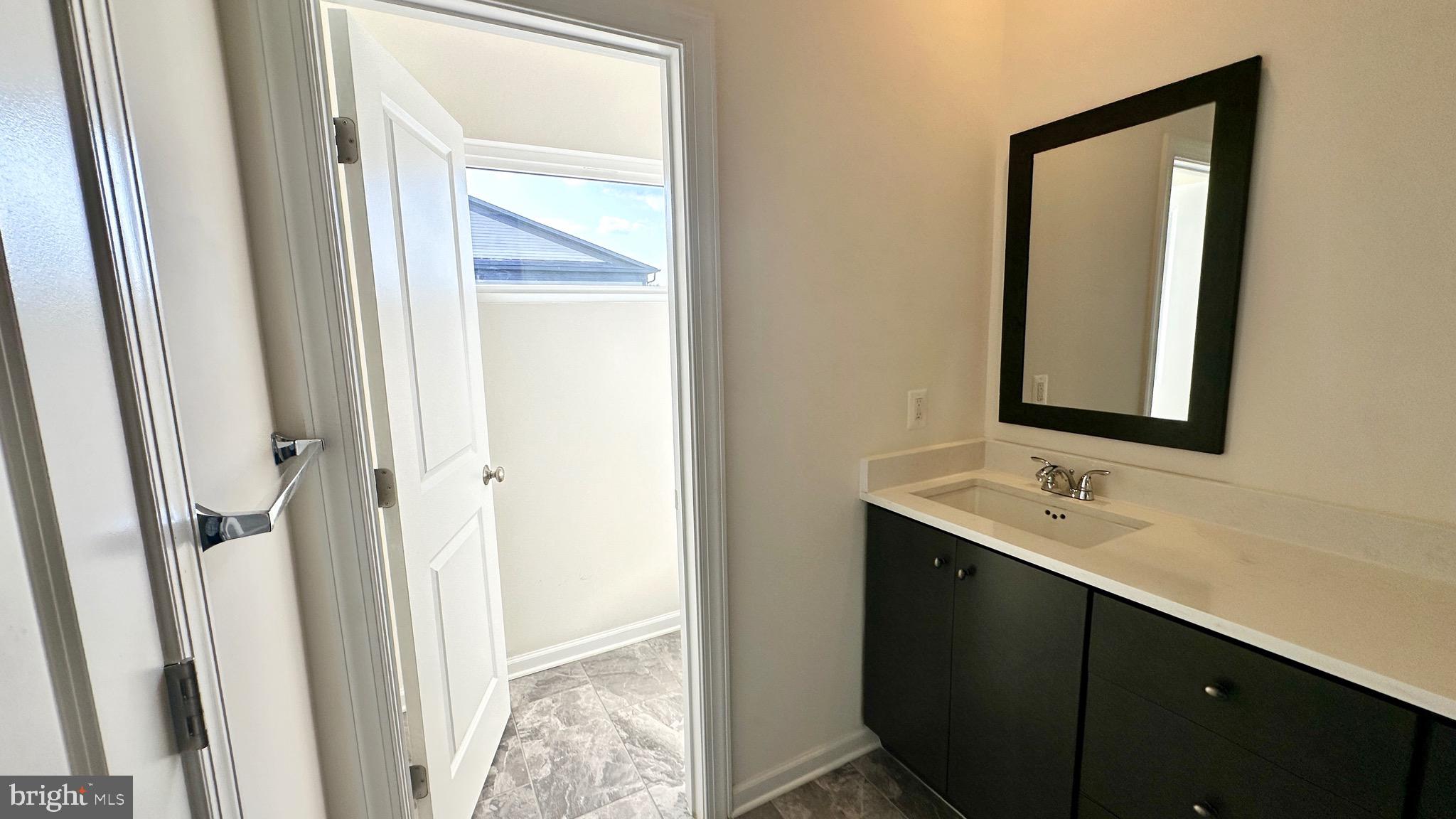 20265 Oak Bluff Drive Ashburn, VA 20147 - Photo 26 of 42 a bathroom with a sink and a mirror