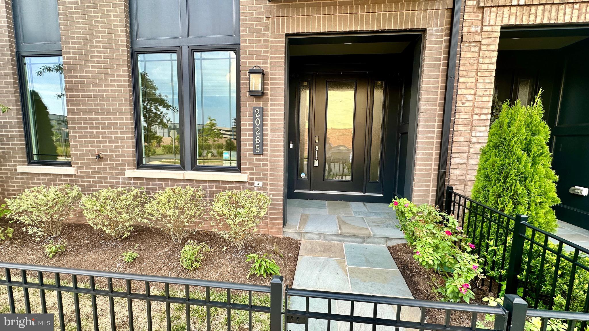 20265 Oak Bluff Drive Ashburn, VA 20147 - Photo 3 of 42 a front view of a house with a porch