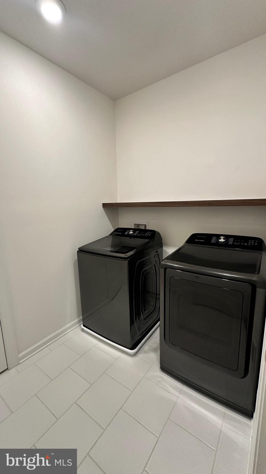 20265 Oak Bluff Drive Ashburn, VA 20147 - Photo 32 of 42 a kitchen with granite countertop white cabinets and black appliances