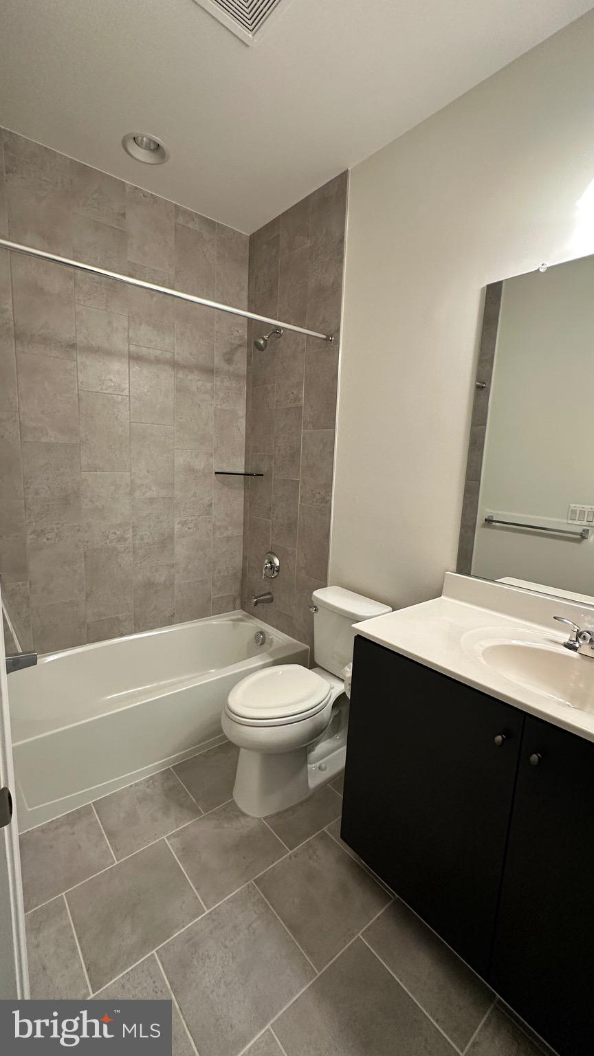 20265 Oak Bluff Drive Ashburn, VA 20147 - Photo 35 of 42 a bathroom with a toilet a sink and shower