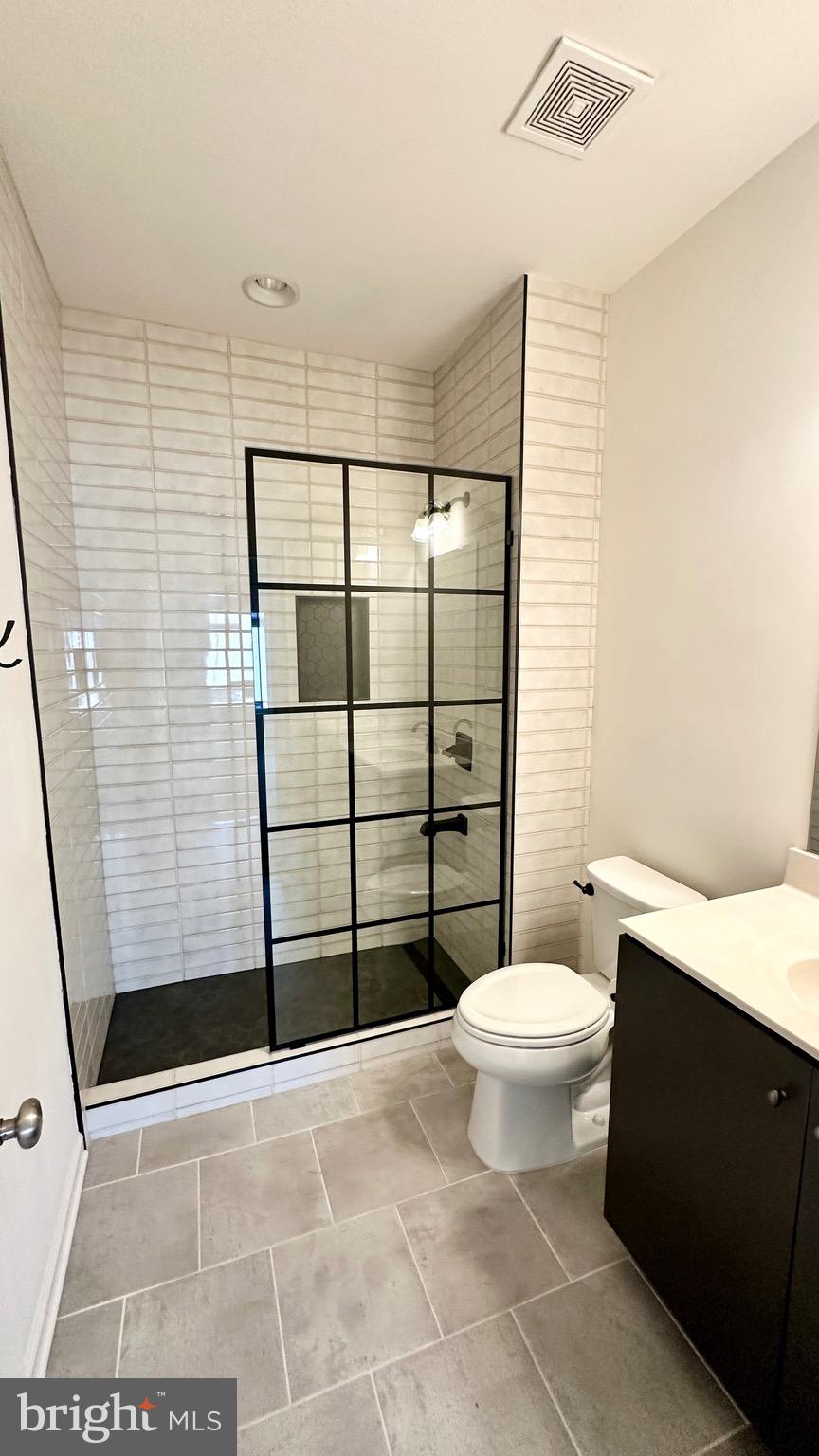 20265 Oak Bluff Drive Ashburn, VA 20147 - Photo 37 of 42 a bathroom with a toilet and a shower