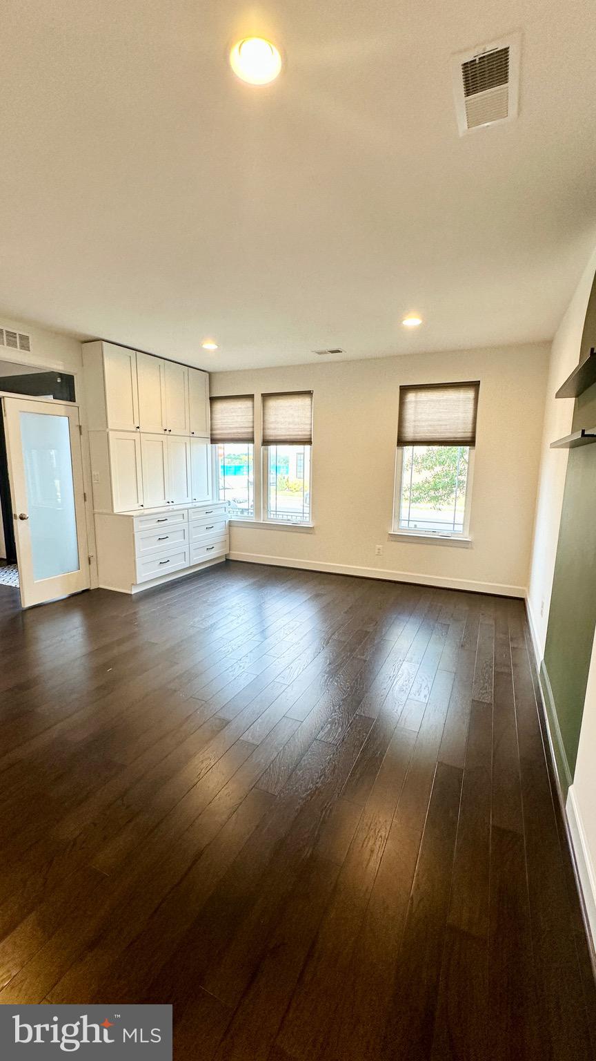 20265 Oak Bluff Drive Ashburn, VA 20147 - Photo 39 of 42 an empty room with wooden floor and windows