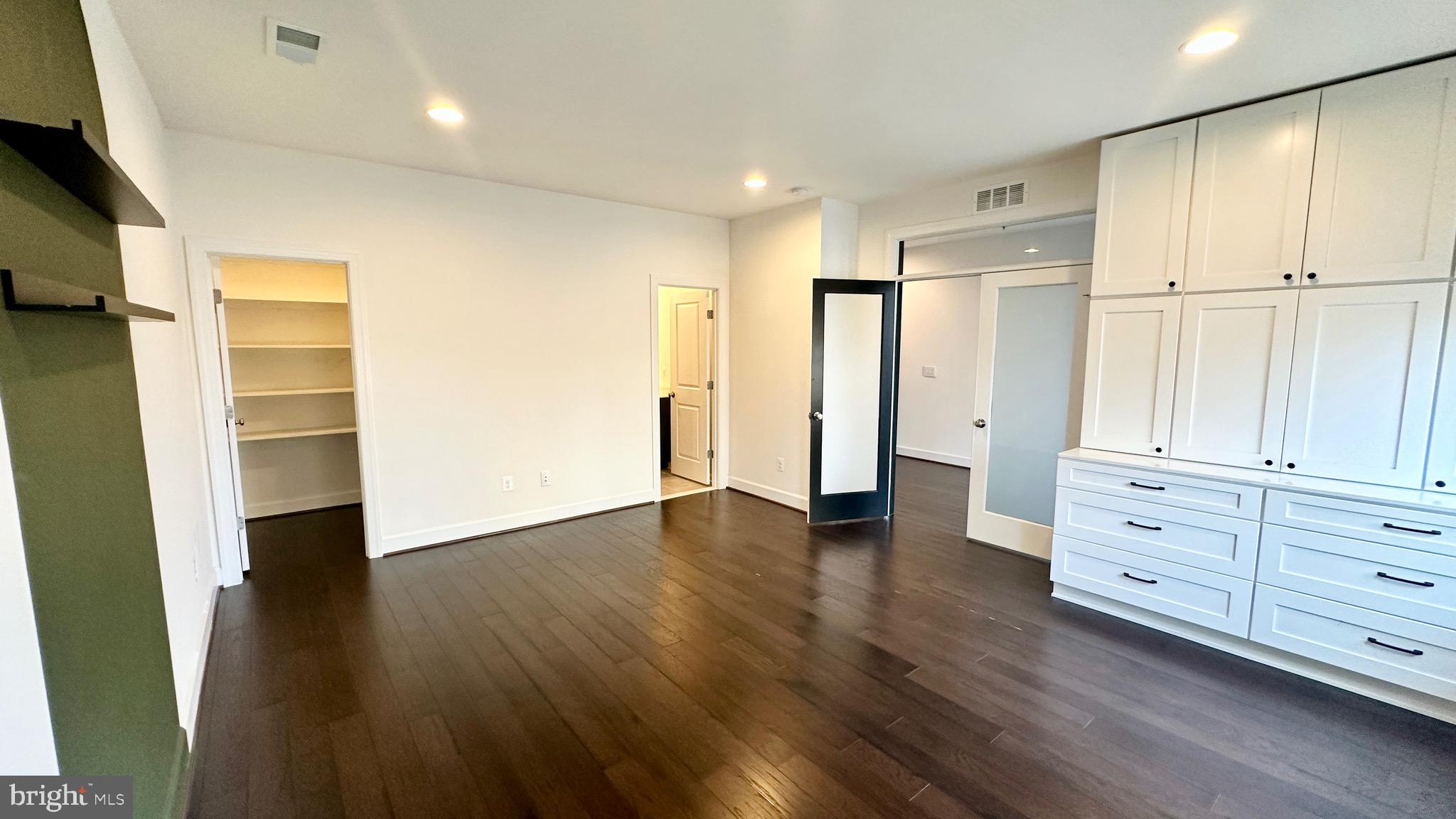20265 Oak Bluff Drive Ashburn, VA 20147 - Photo 6 of 42 a view of an empty room with wooden floor and closet area