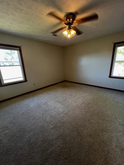 1966 Highway 142 Covington, GA 30014 - Photo 61 of 96 an empty room with a chandelier fan and windows