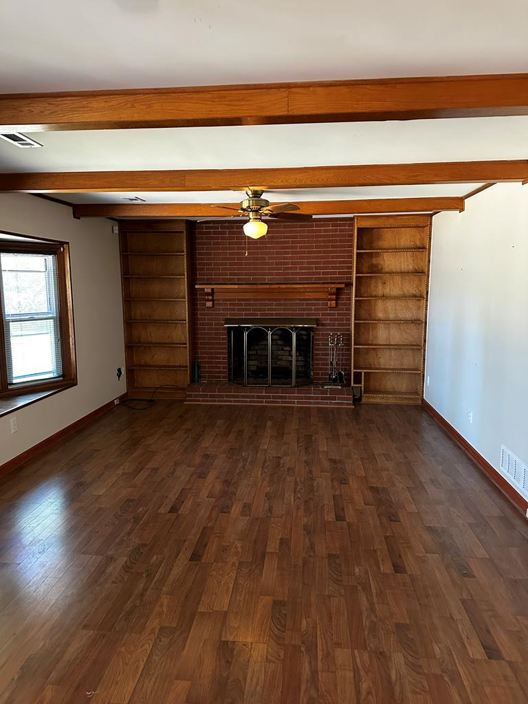 1966 Highway 142 Covington, GA 30014 - Photo 75 of 96 an empty room with wooden floor fireplace and windows