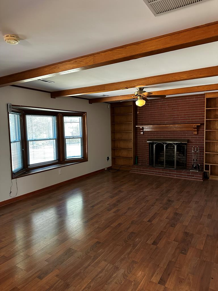 1966 Highway 142 Covington, GA 30014 - Photo 76 of 96 a view of empty room with wooden floor and fireplace