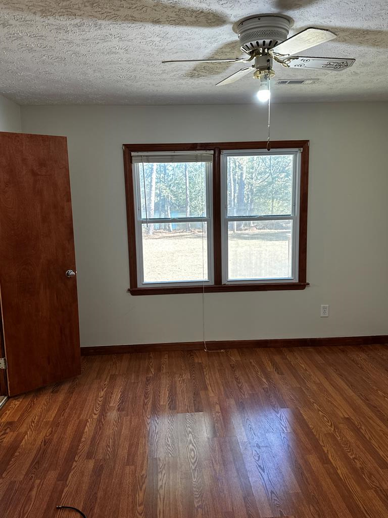 1966 Highway 142 Covington, GA 30014 - Photo 88 of 96 a view of an empty room with wooden floor and a window