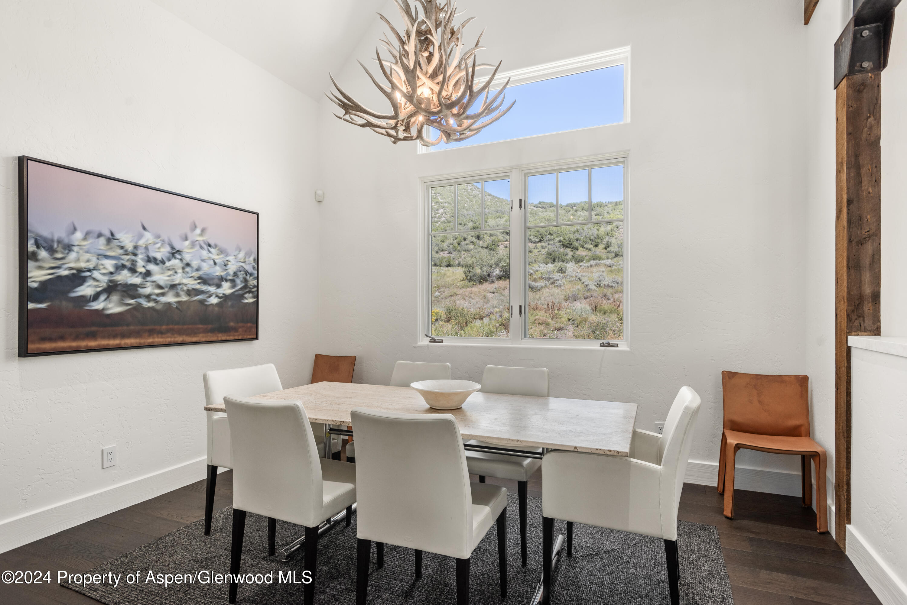 124 Trail Rider Lane Snowmass Village, CO 81615 - Photo 11 of 39 a view of a dining room with furniture window and wooden floor