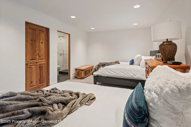 a bedroom with furniture and a window