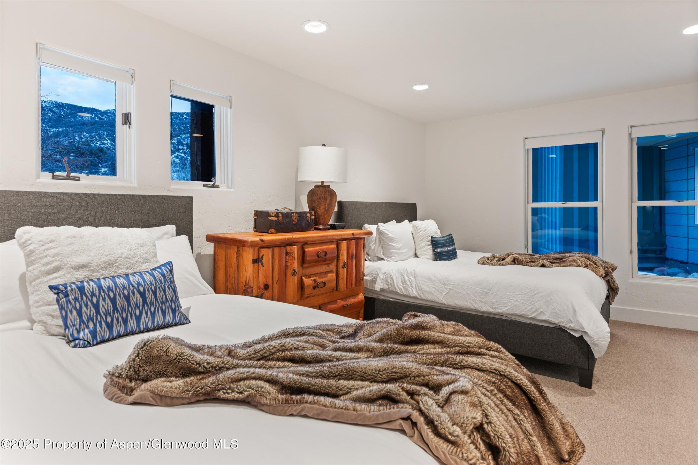 124 Trail Rider Lane Snowmass Village, CO 81615 - Photo 20 of 39 a bedroom with a bed and window
