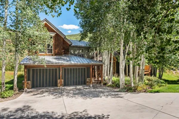 a front view of a house with yard and green space