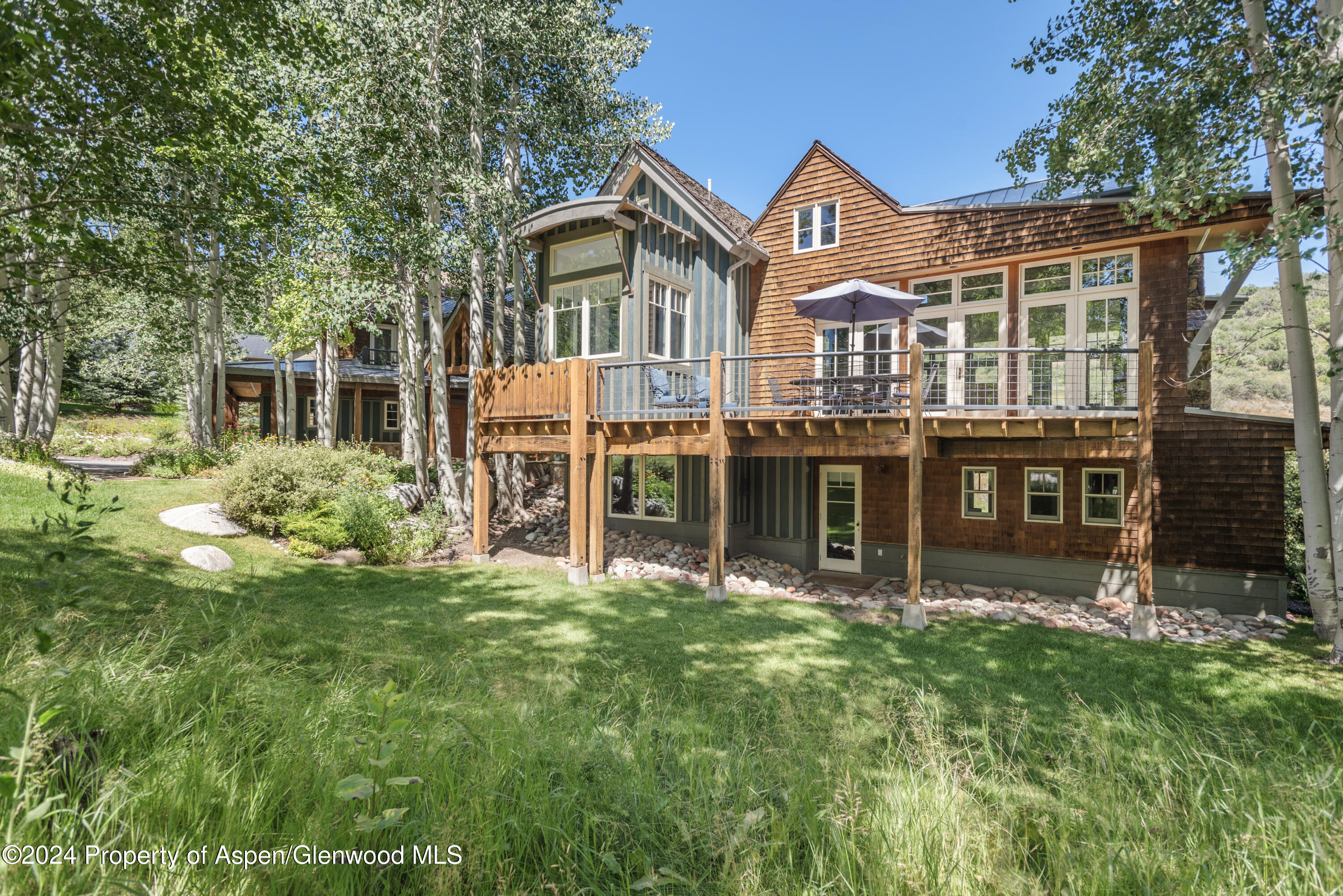 124 Trail Rider Lane Snowmass Village, CO 81615 - Photo 32 of 39 a front view of a house with a yard table and chairs