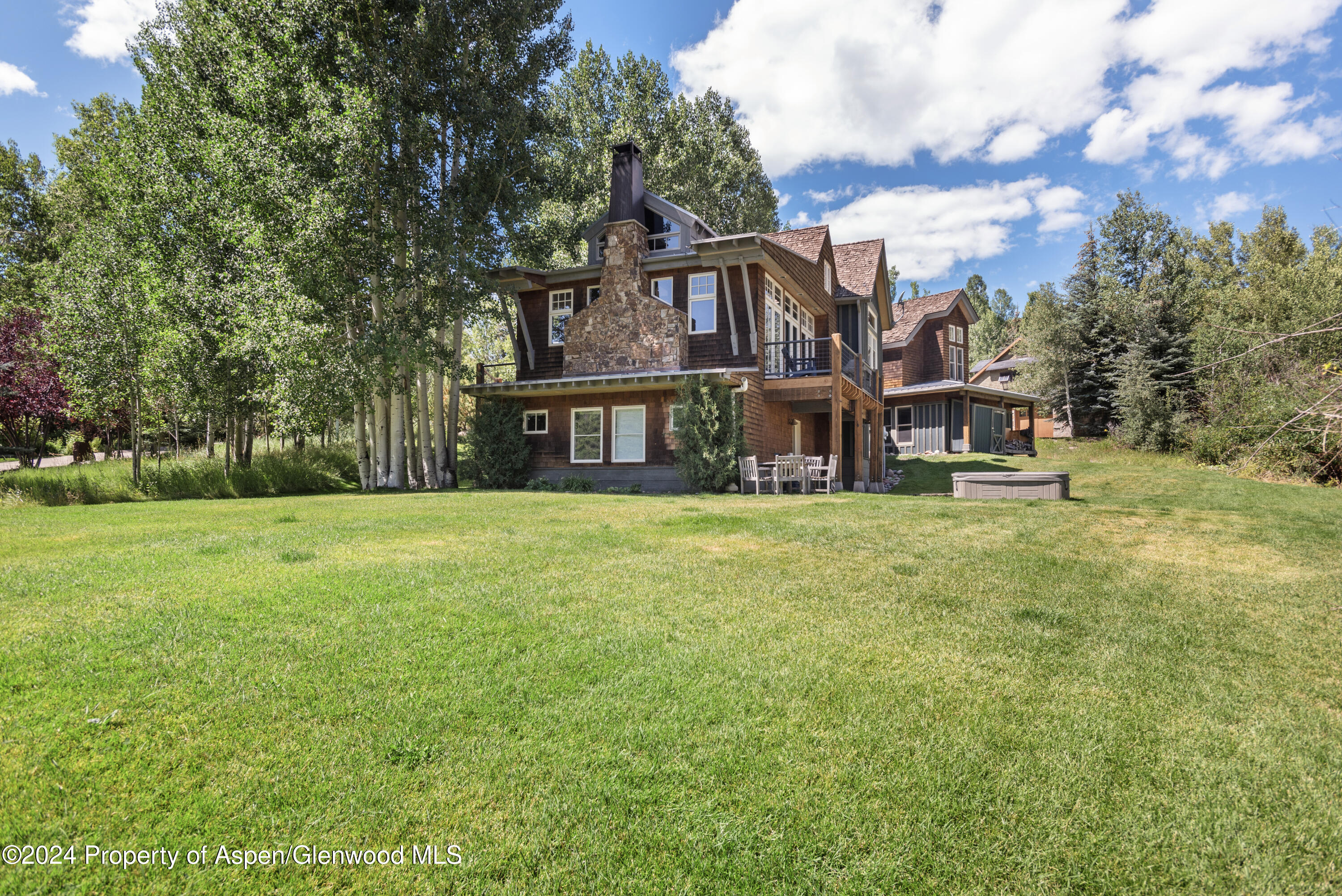 124 Trail Rider Lane Snowmass Village, CO 81615 - Photo 33 of 39 a front view of a house with garden