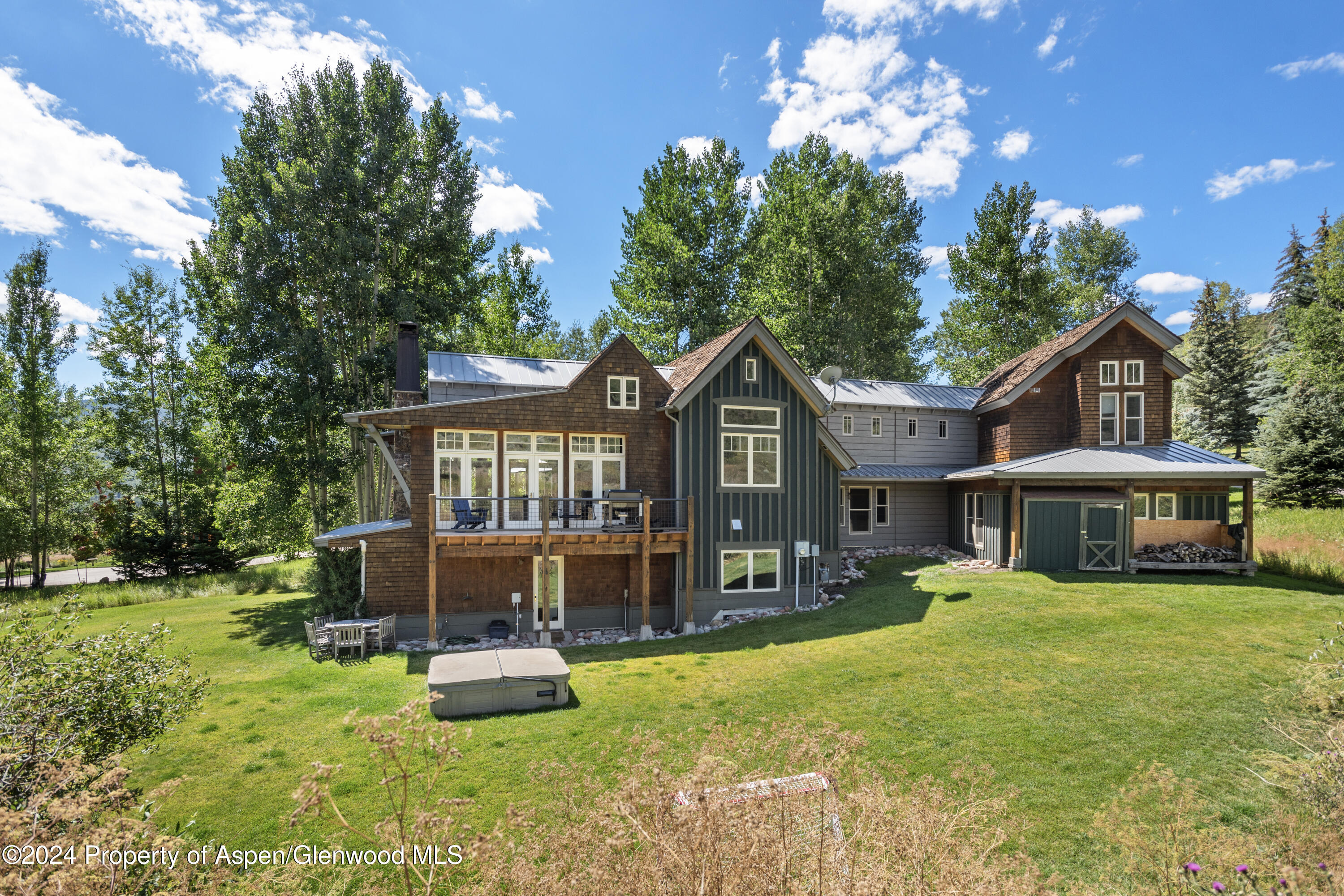 124 Trail Rider Lane Snowmass Village, CO 81615 - Photo 34 of 39 a front view of a house with yard and green space