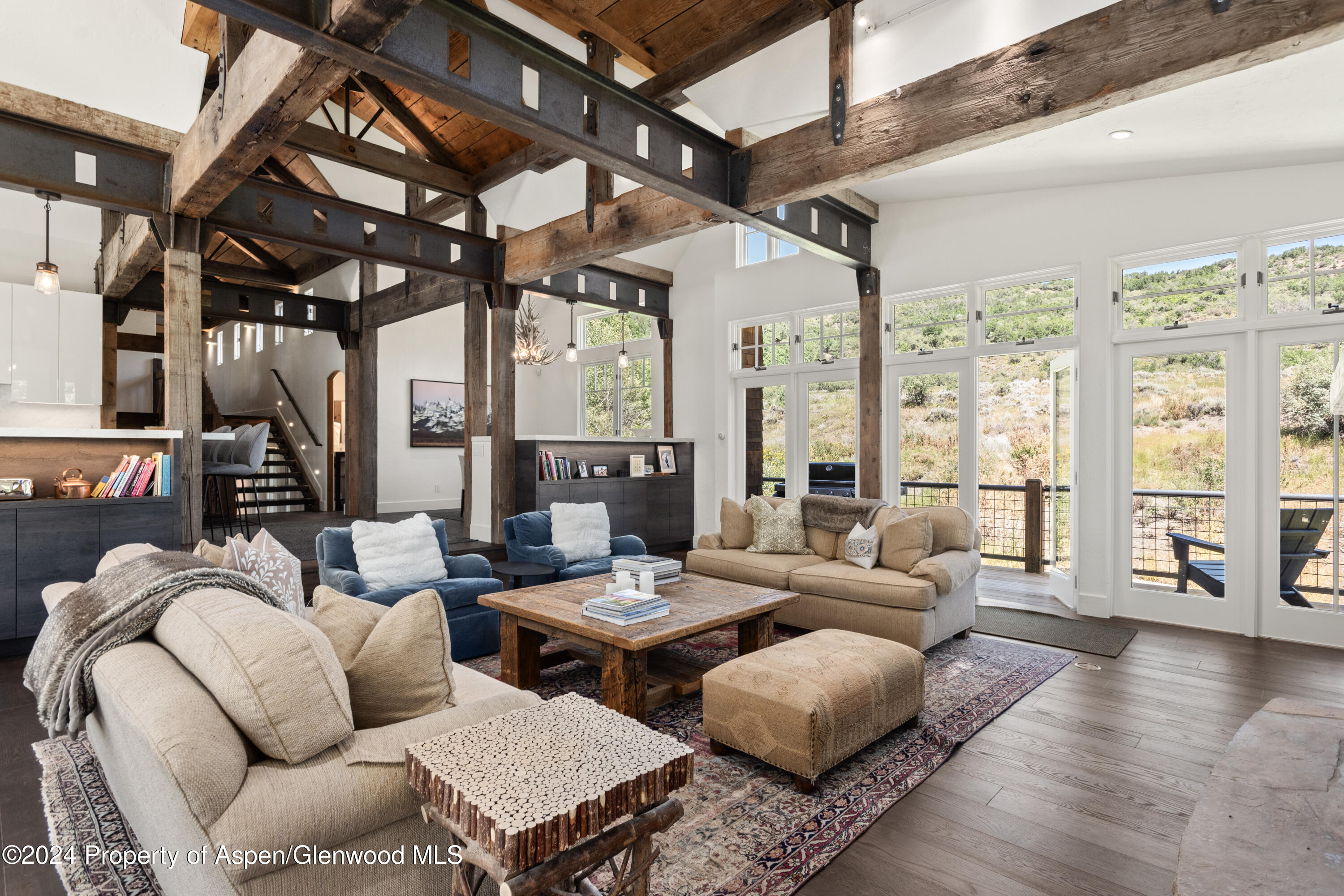 124 Trail Rider Lane Snowmass Village, CO 81615 - Photo 6 of 39 a living room with furniture and a large window