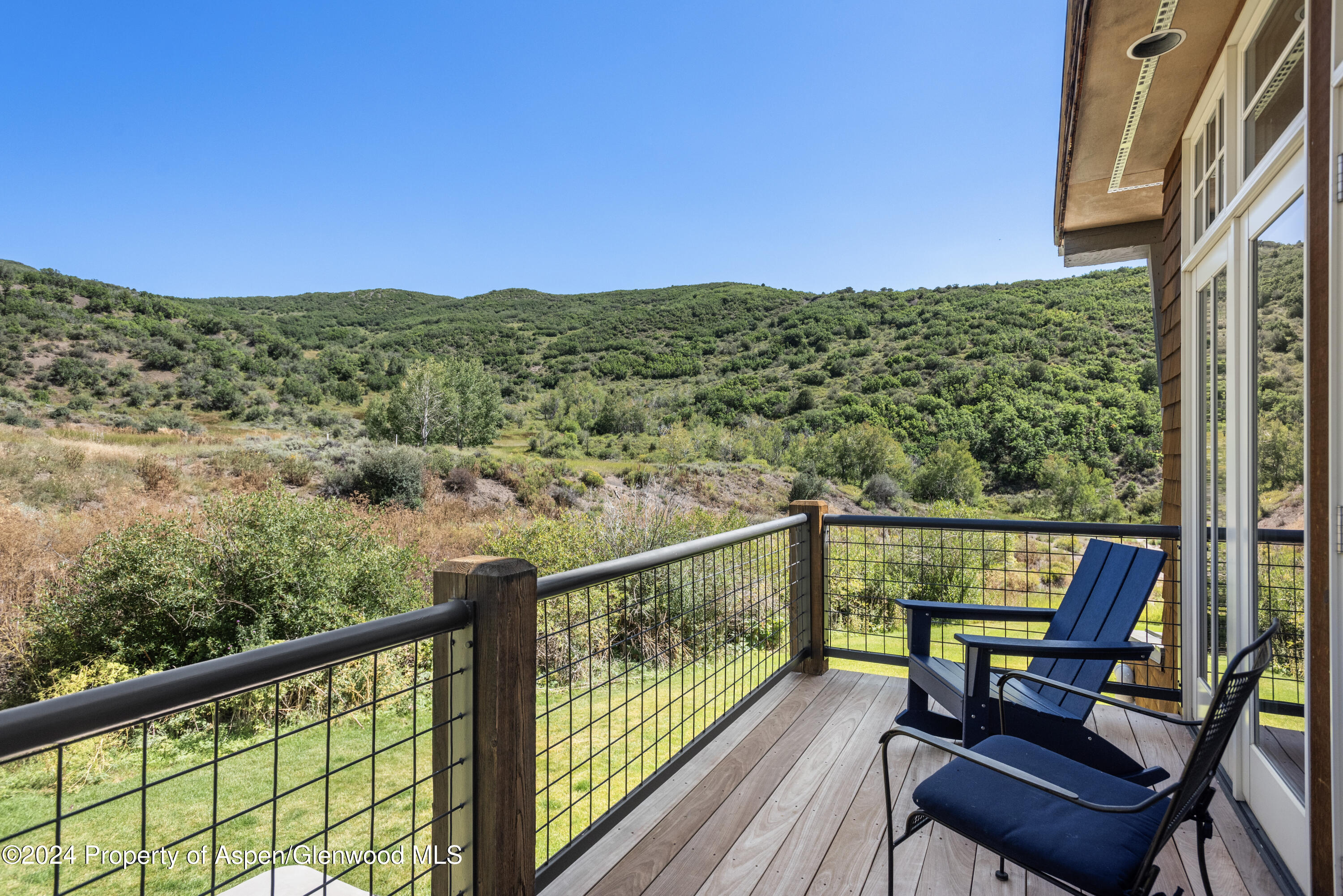 124 Trail Rider Lane Snowmass Village, CO 81615 - Photo 10 of 39 a view of a city from a balcony with chairs