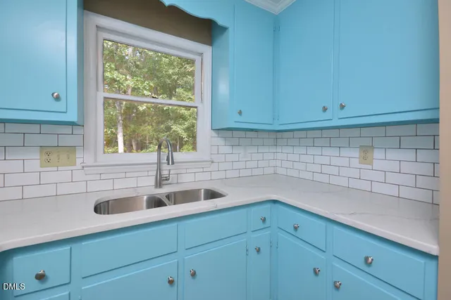 a kitchen with a sink and cabinets