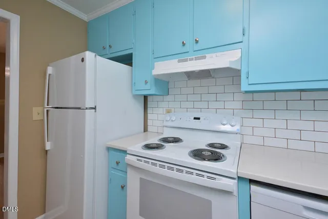 a kitchen with refrigerator and cabinets