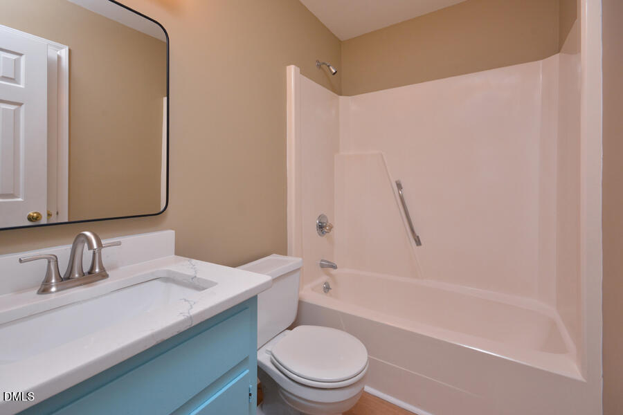 11 Tarawa Terrace, Unit B Durham, NC 27705 - Photo 16 of 32 a bathroom with a sink a toilet and a mirror
