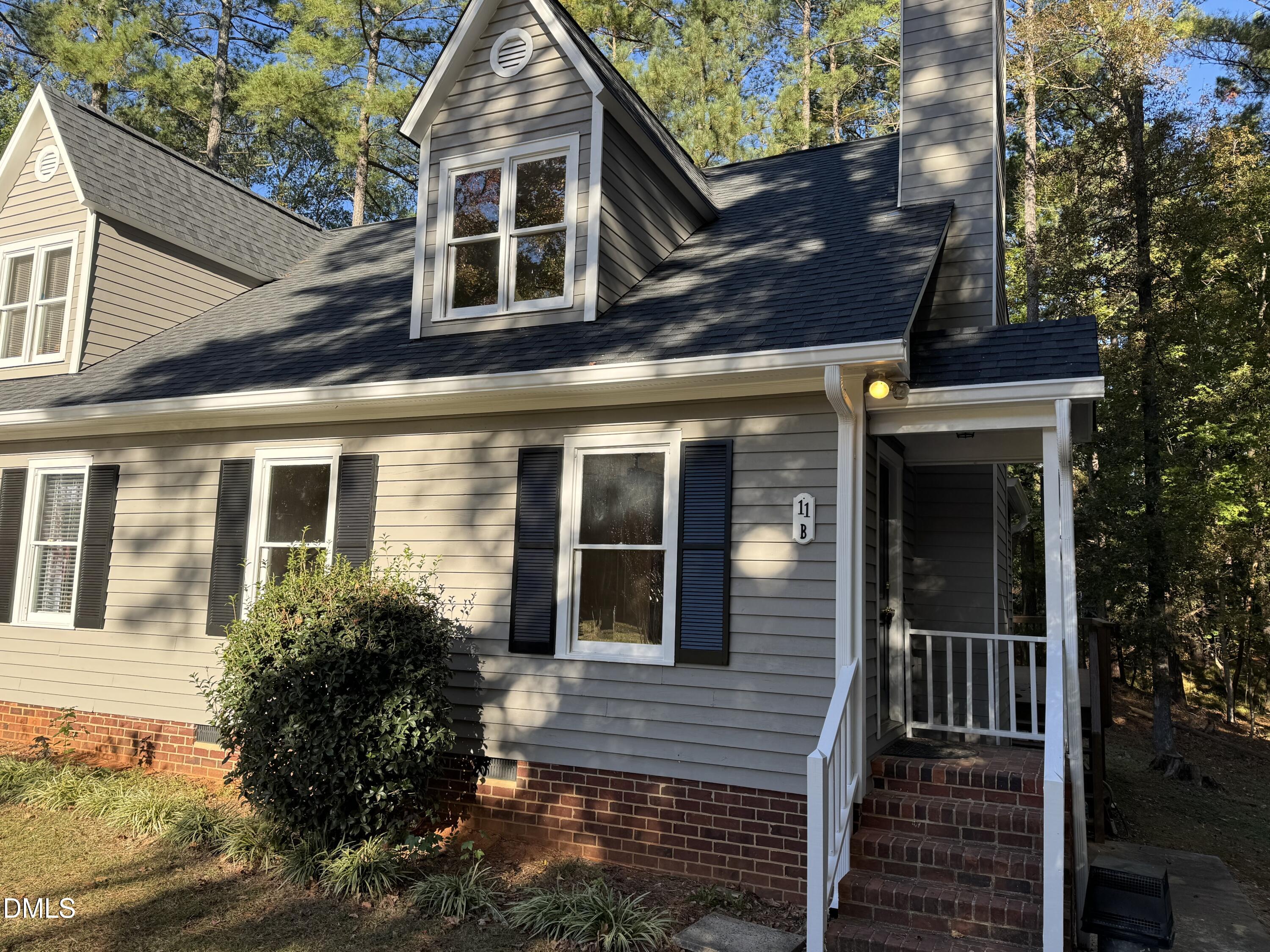 11 Tarawa Terrace, Unit B Durham, NC 27705 - Photo 2 of 32 a view of a brick house with large windows and a large tree