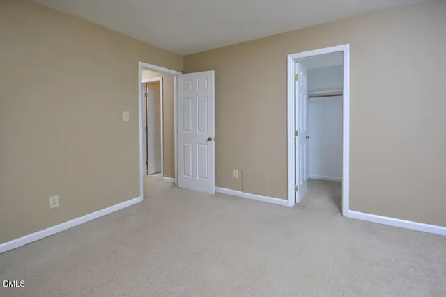 a view of an empty room and closet area