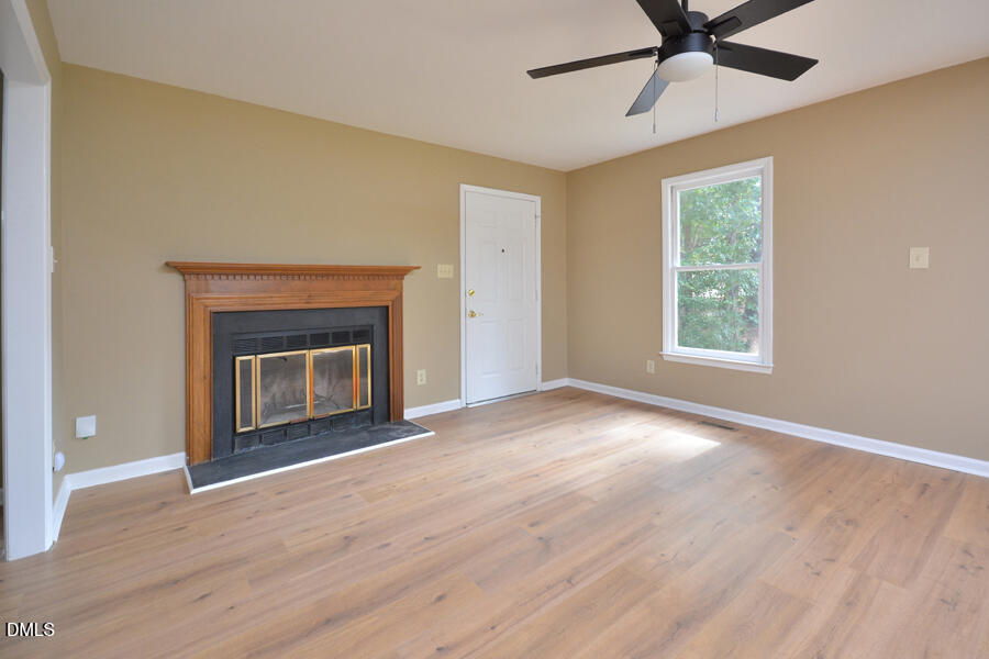 11 Tarawa Terrace, Unit B Durham, NC 27705 - Photo 5 of 32 a view of empty room with a fireplace and wooden floor