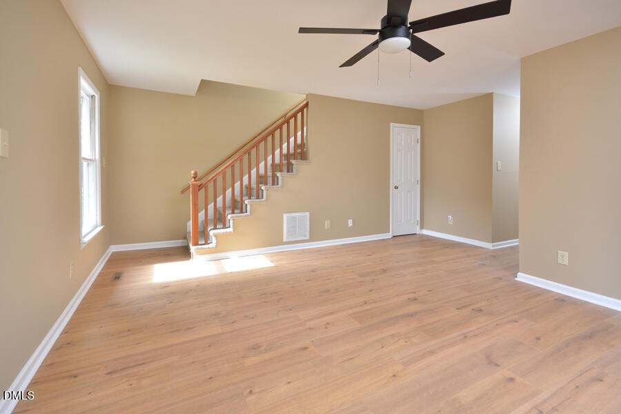 11 Tarawa Terrace, Unit B Durham, NC 27705 - Photo 6 of 32 a view of an empty room with wooden floor and windows