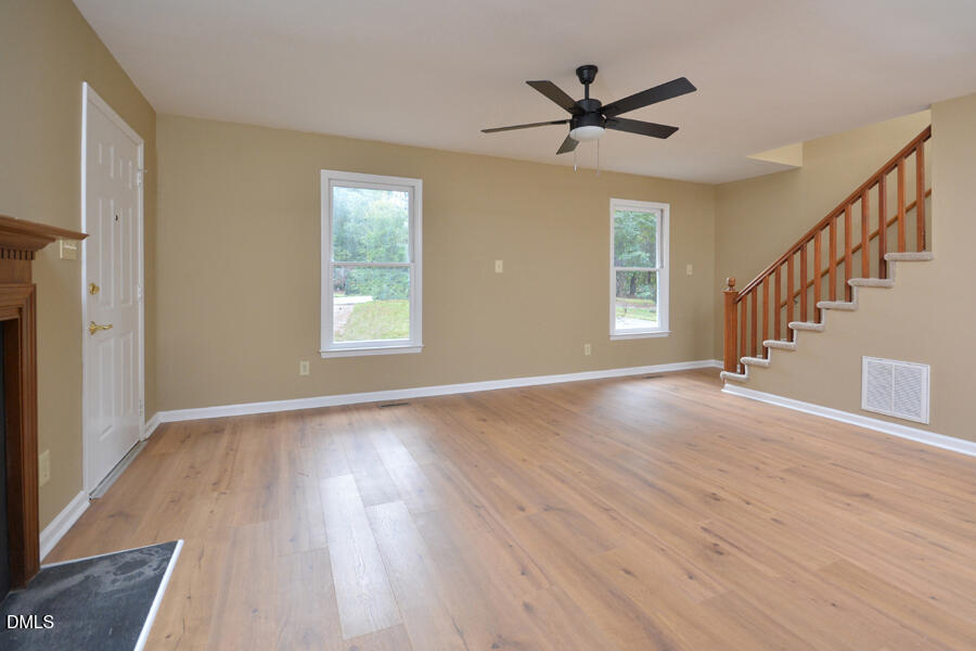 11 Tarawa Terrace, Unit B Durham, NC 27705 - Photo 9 of 32 a view of a livingroom with wooden floor and a ceiling fan