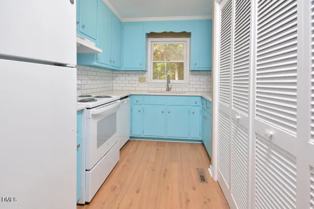 a bathroom with a sink a washer and dryer