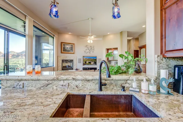 a dining room with furniture large windows and wooden floor