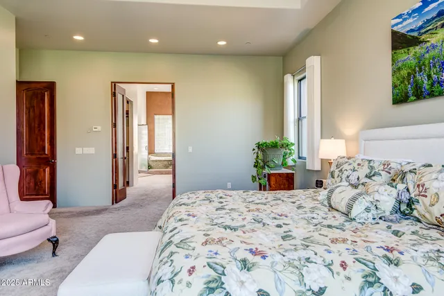 a bedroom with a bed and a chandelier