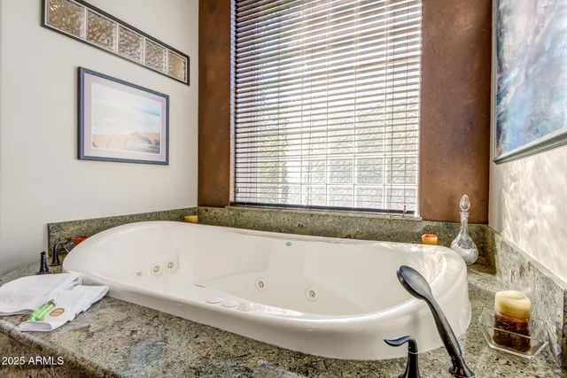 a view of a living room with furniture and a floor to ceiling window