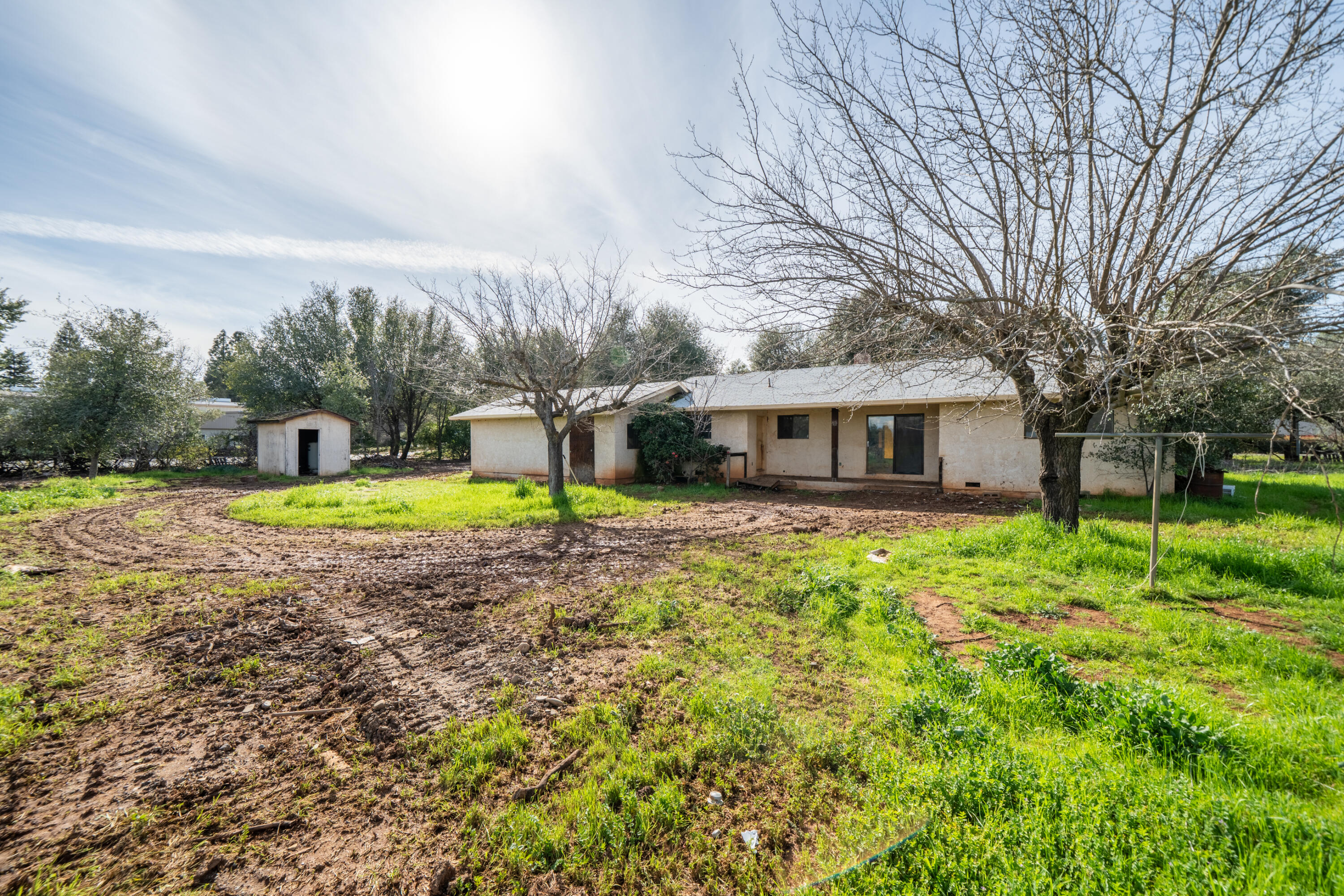 8743 Airport Road Redding, CA 96002 - Photo 25 of 39 BACK OF HOME WITH PUMP HOUSE
