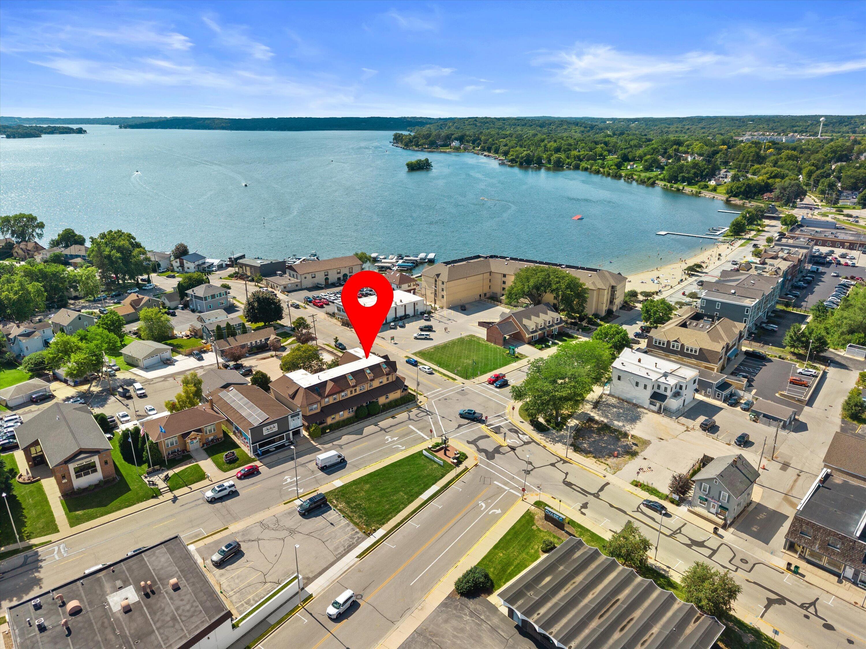 100 Main Street, Unit 102 Pewaukee, WI 53072 - Photo 24 of 30 Stroll to Pewaukee Lake, Pewaukee Beach, Lakefront Park, shops and restaurants, and enjoy unforgettable sunsets along the waterfront