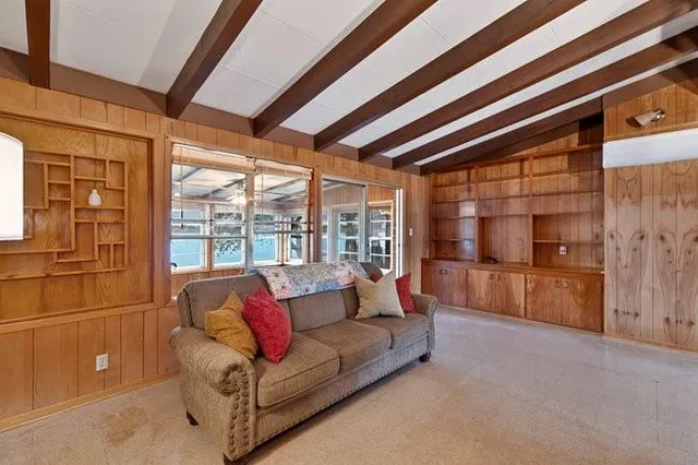 a living room with furniture and a floor to ceiling window