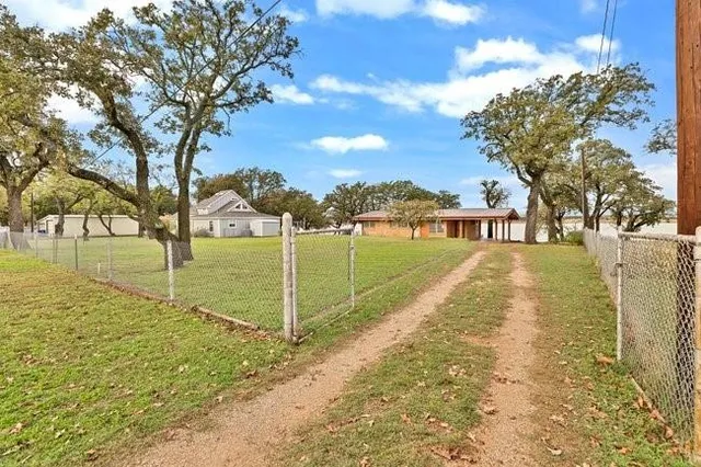 a view of yard with swimming pool and an outdoor seating