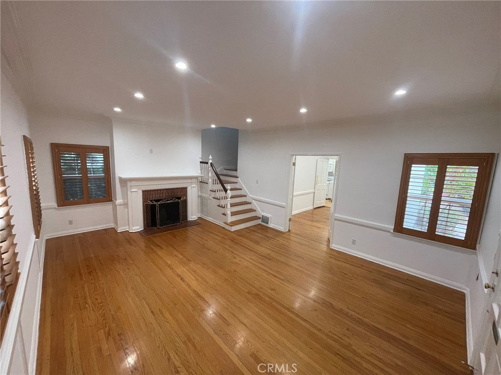 135 Canon Drive Beverly Hills, CA 90212 - Photo 12 of 42 a view of an empty room with wooden floor and a fireplace